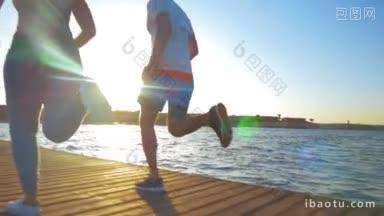 斯坦尼康慢动作拍摄的两个运动的人在早上慢跑，他们很好地与升起的太阳